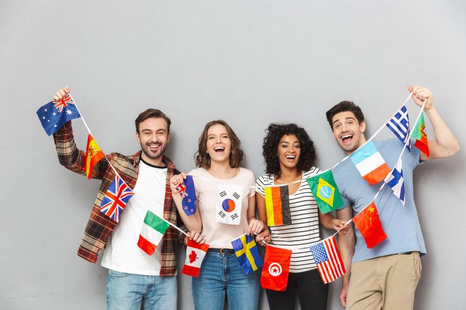 Young people holding string of international flags